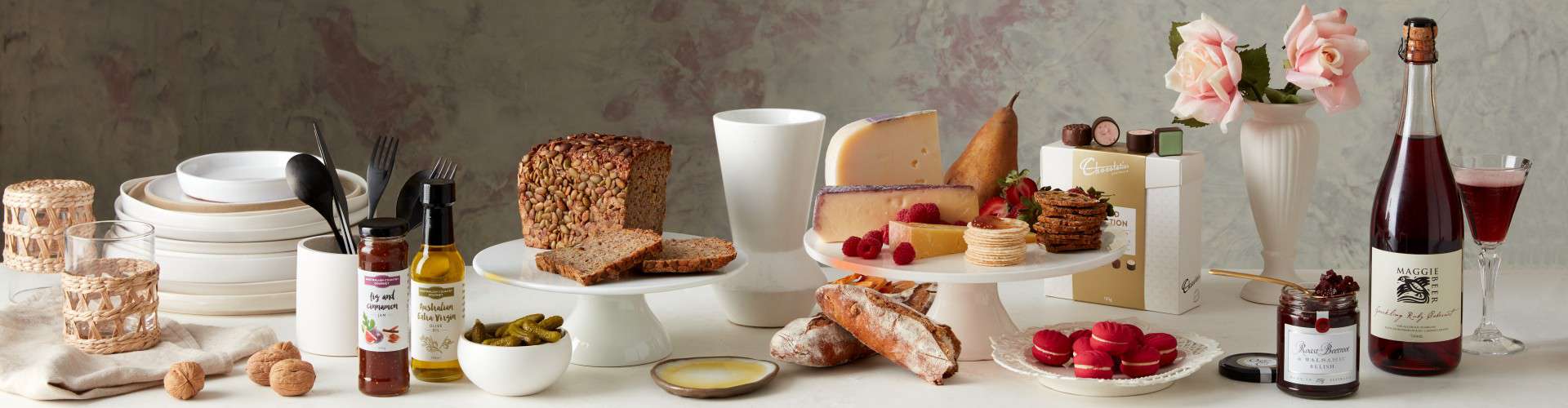 A gourmet food setting of the products contained in our Gourmet Hampers with cheese, fruit and platters